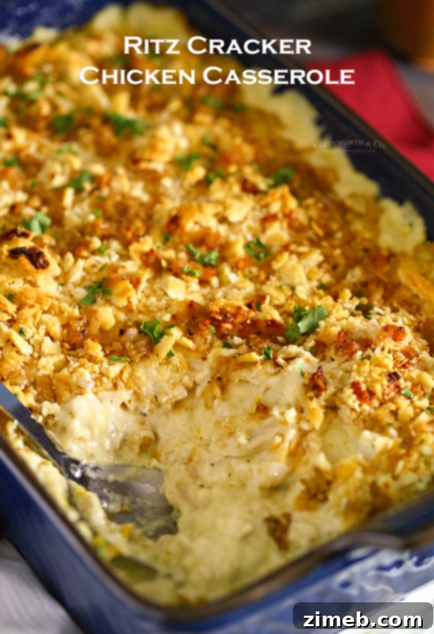 Close-up of golden Ritz cracker topping on a bubbling chicken casserole.