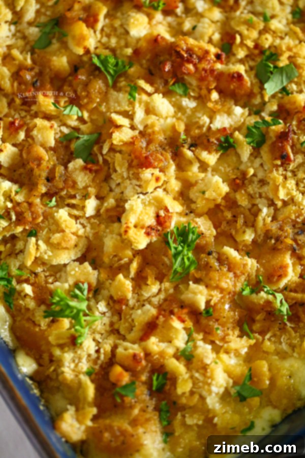 A top-down view of a creamy chicken casserole with a golden Ritz cracker crust, ready to be served.