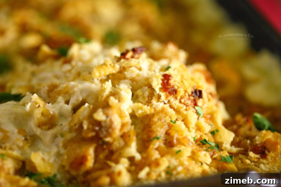 A wide shot of a baked Ritz cracker chicken casserole in a serving dish, steam rising.