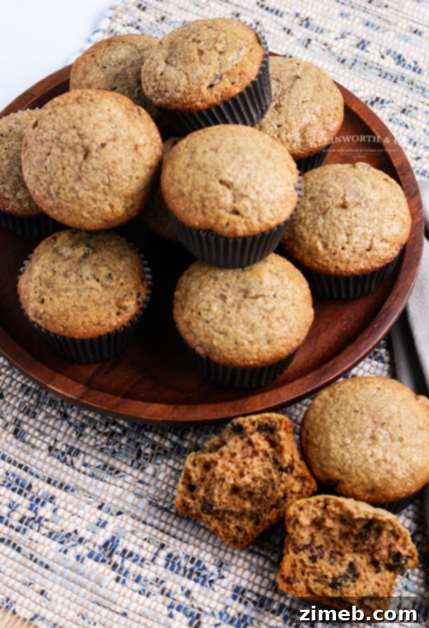 Close-up of a freshly baked applesauce muffin, showcasing its golden-brown top and tender crumb.