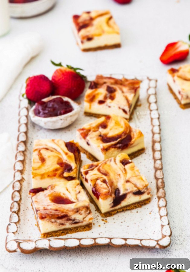 Luscious Strawberry Cheesecake Squares 3 Swirled cheesecake squares featuring strawberry jam