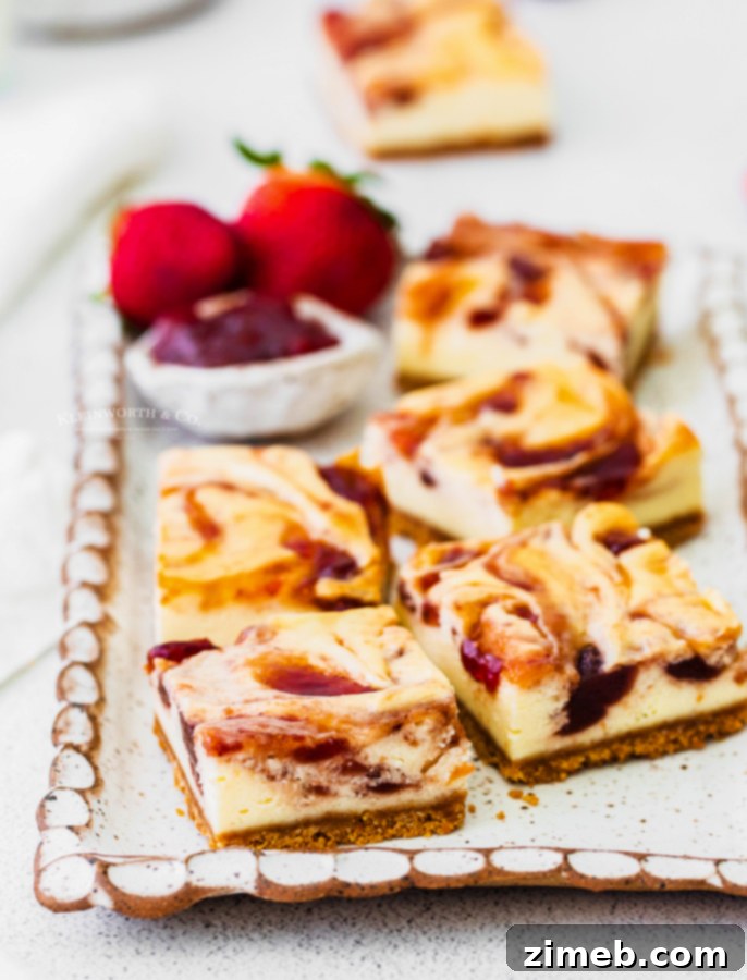 Luscious Strawberry Cheesecake Squares 4 Strawberry swirl cheesecake bars ready to be served