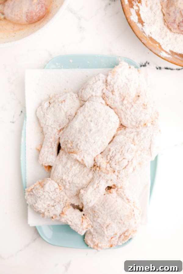 Flour coated chicken pieces on a plate