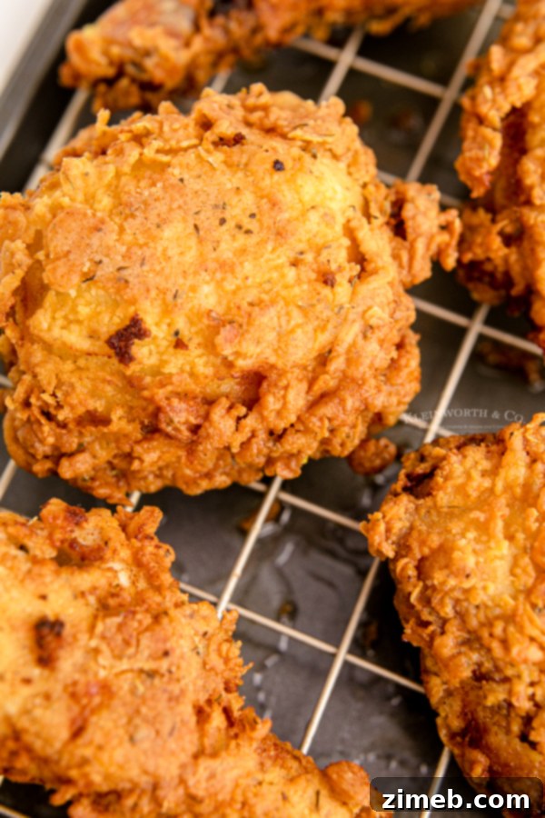 Cooked chicken draining on a wire rack