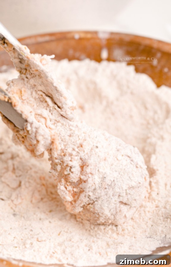 Flour coated chicken drumstick ready for frying