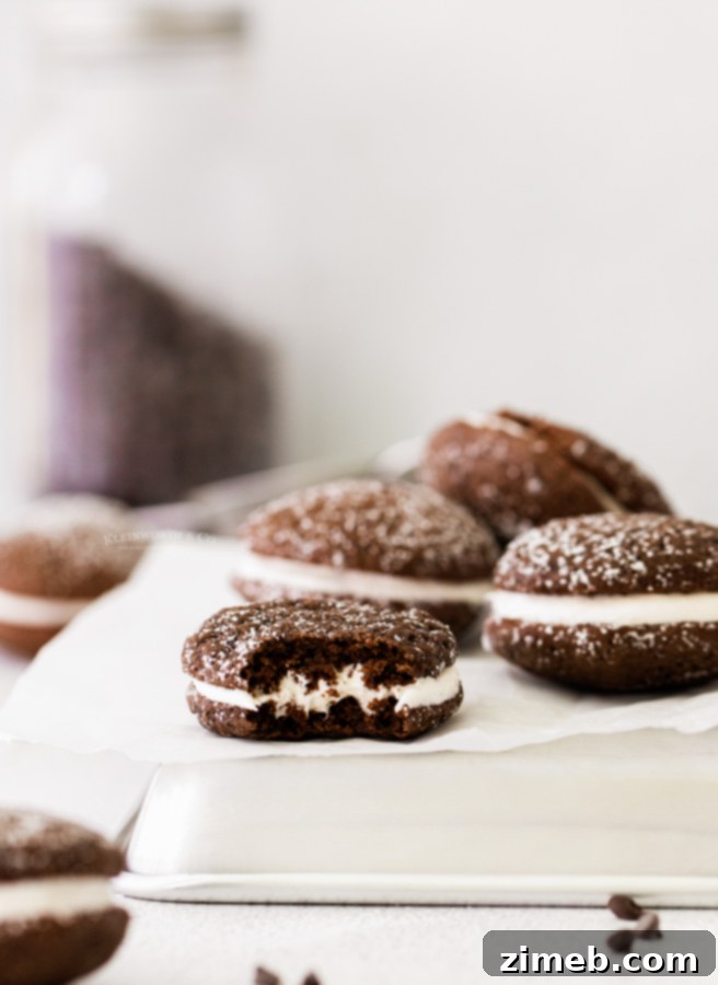 Decadent Whoopie Pie Delights 21 A delicious bite of a whoopie pie sandwich cookie, showcasing its fluffy texture and creamy filling.