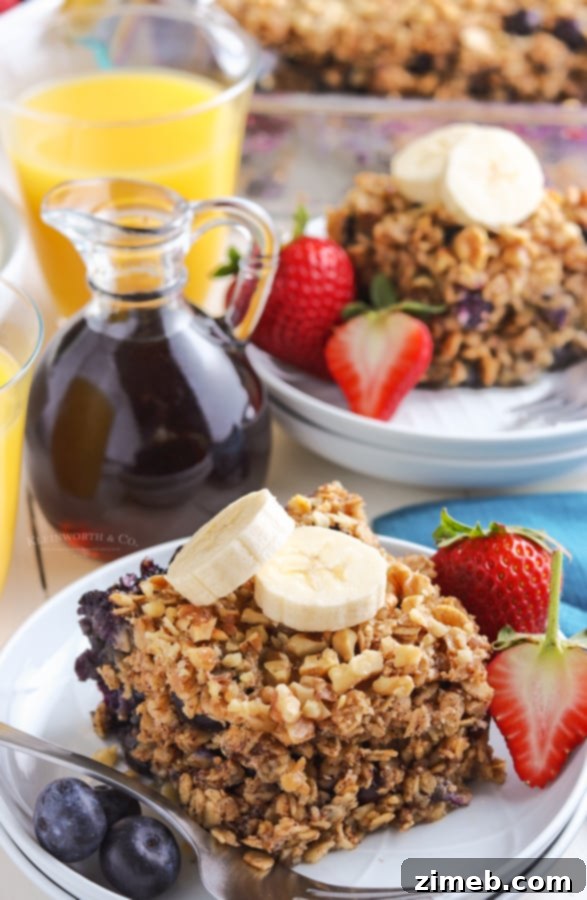 Warm Blueberry Oat Bake 3 A serving of baked oatmeal garnished with fresh fruit, showcasing its hearty texture and appealing presentation. A perfect blend of comfort and nutrition.