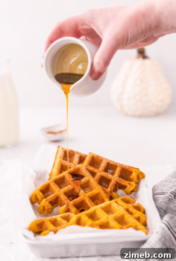Warm pumpkin waffles drizzled with maple syrup