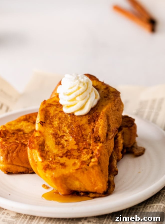 Pumpkin French Toast topped with whipped cream and a sprinkle of cinnamon