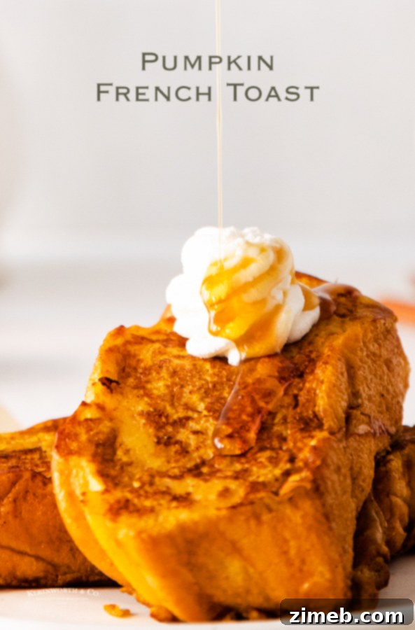 Beautifully stacked Pumpkin French Toast with powdered sugar and maple syrup, ready to eat