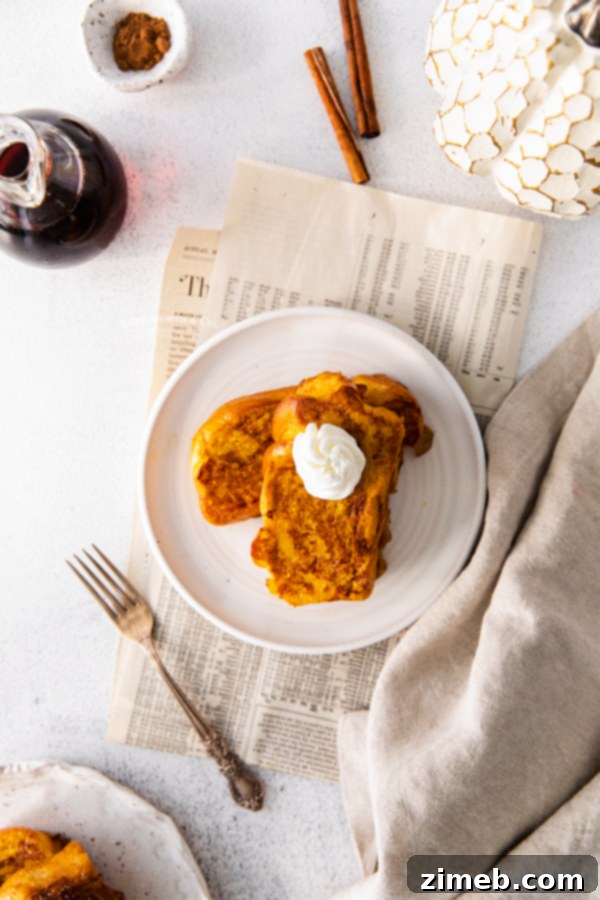 Stack of pumpkin toast brioche, garnished with powdered sugar and a sprig of mint