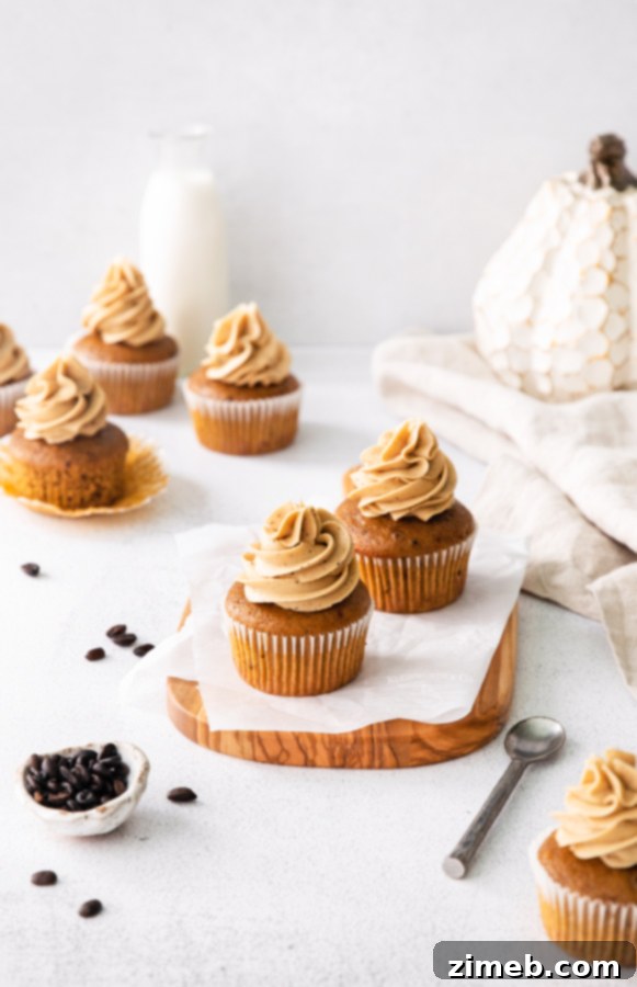 Moist pumpkin cupcakes cooling on a wire rack