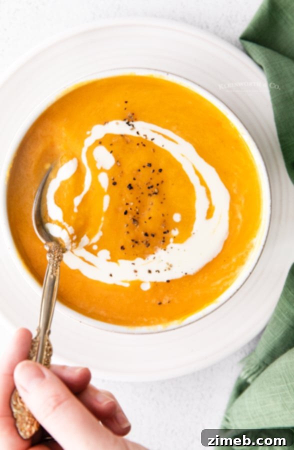 Velvety Instant Pot Butternut Squash Soup 12 Instant Pot Squash Soup - A full bowl of Instant Pot butternut squash soup, garnished with a sprinkle of black pepper and a sprig of fresh sage, ready to be enjoyed.