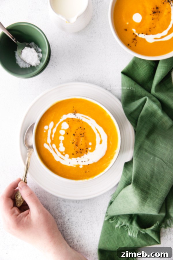 Velvety Instant Pot Butternut Squash Soup 3 Best Butternut Squash Soup - A close-up of a bowl of golden butternut squash soup, perfectly blended and ready to serve. The lighting highlights its smooth texture and appetizing color.