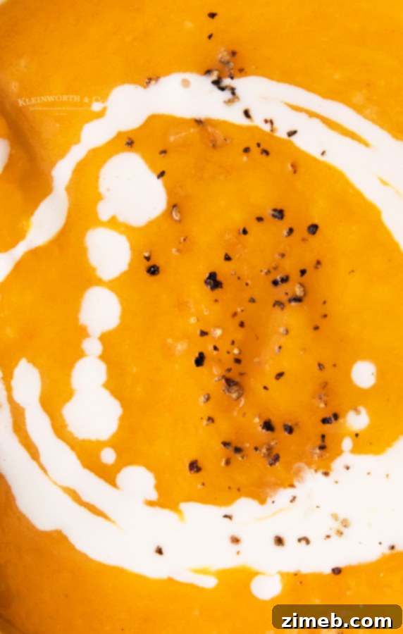 Velvety Instant Pot Butternut Squash Soup 4 Butternut Squash Soup with cream - A bowl of creamy butternut squash soup, freshly blended and swirled with heavy cream, garnished with sage leaves. The image emphasizes the luxurious texture.