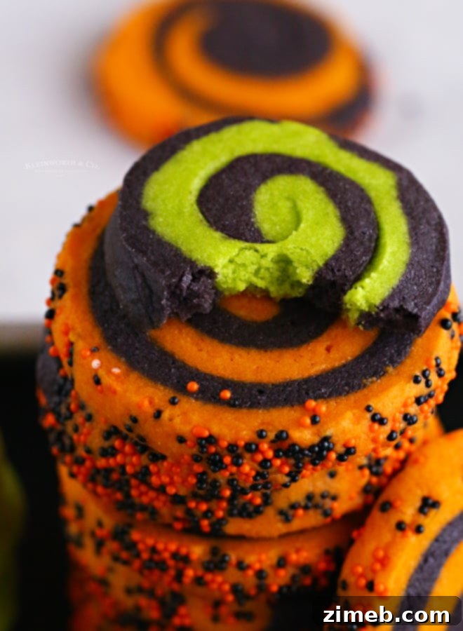 Wickedly Delicious Halloween Cookies 14 Close-up of vibrant pinwheel sugar cookies on a cooling rack