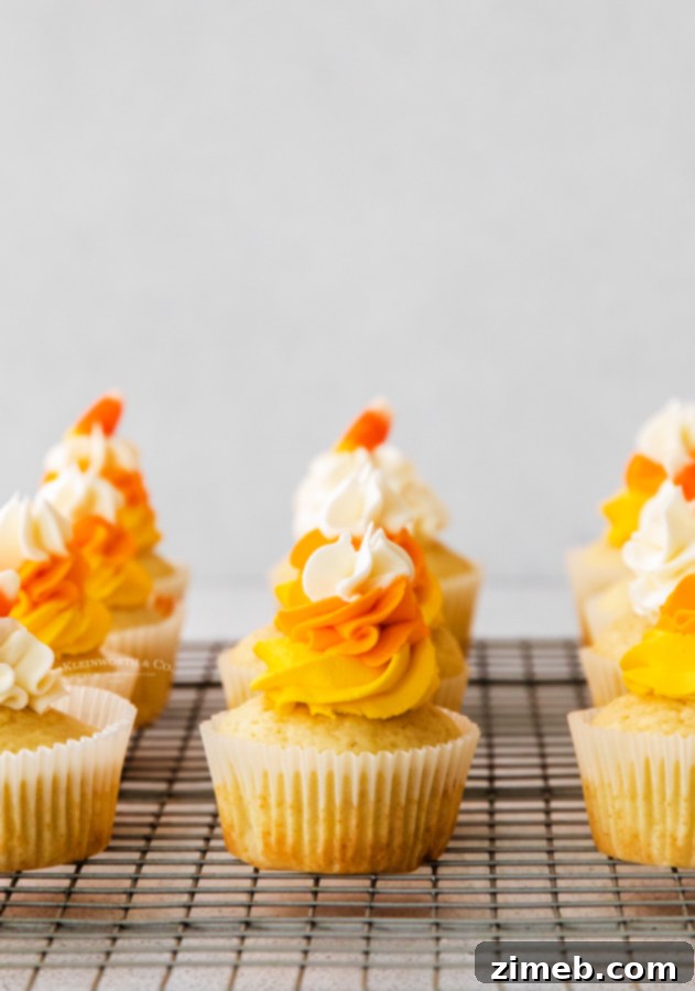 Harvest Harmony Cupcakes 3 Close-up of fall cupcakes adorned with candy corn themed frosting.