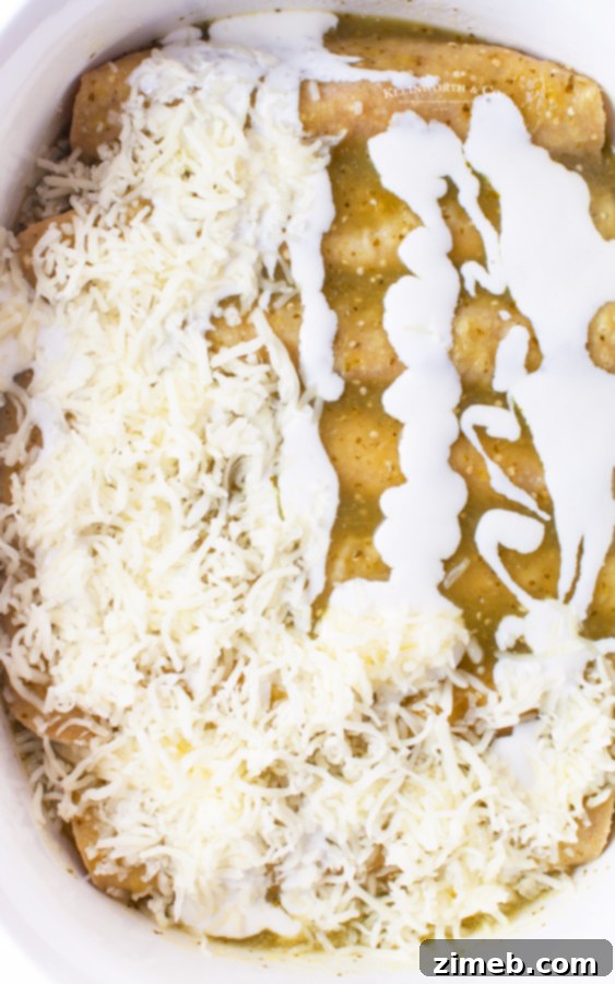 Adding cheese to Chicken Enchiladas Verde before baking