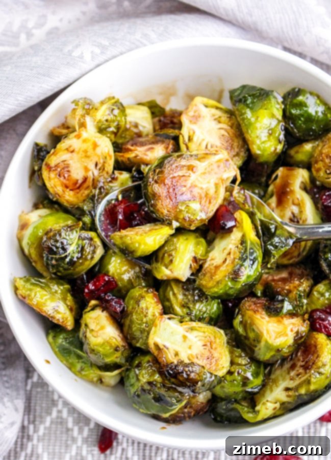 Sticky Sweet Balsamic Brussels 18 Overhead shot of a platter of balsamic-glazed Brussels sprouts with cranberries, beautifully arranged.