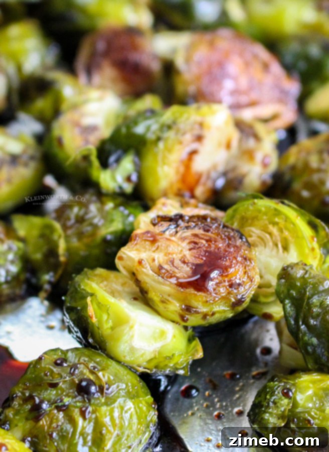 Sticky Sweet Balsamic Brussels 4 Serving dish of balsamic roasted Brussels sprouts with a generous scattering of dried cranberries.