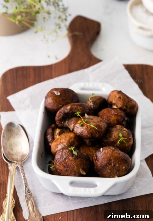 Golden Garlic Thyme Roasted Mushrooms 18 A close-up of oven roasted mushrooms with garlic and thyme in a serving bowl, showcasing their golden-brown texture, perfect as a dinner side.