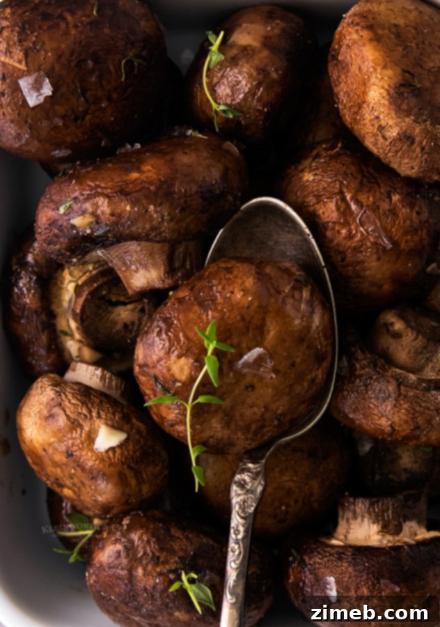 Golden Garlic Thyme Roasted Mushrooms 19 A vibrant bowl of oven baked mushrooms, seasoned with herbs, providing a healthy and appetizing side for any meal.