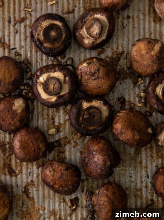 Golden Garlic Thyme Roasted Mushrooms 7 A baking sheet filled with perfectly baked mushrooms, golden brown and tender, ready to be served as a delightful side.