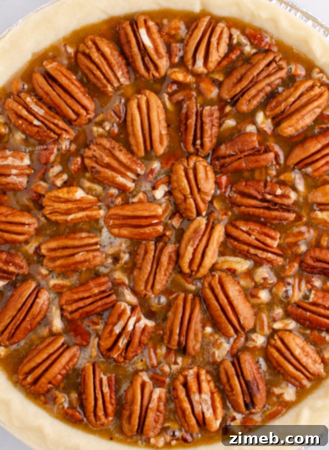 Foolproof Pecan Pie 12 adding pecans to the pie before baking