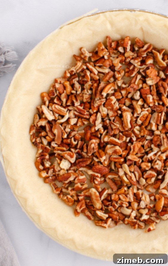 Foolproof Pecan Pie 8 how to make Easy Pecan Pie - pouring filling into crust