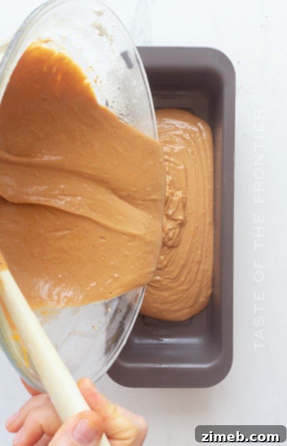 Spiced Ginger Delight 7 Pouring Gingerbread Cake batter into a loaf pan, an essential step in creating a delicious homemade gingerbread loaf.