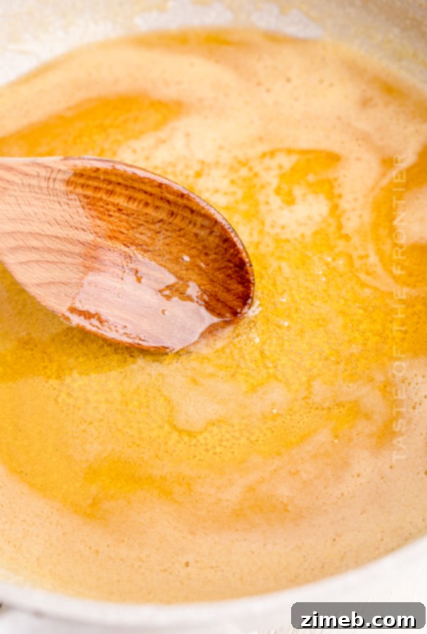 Close-up of golden honey sauce being prepared in a pot