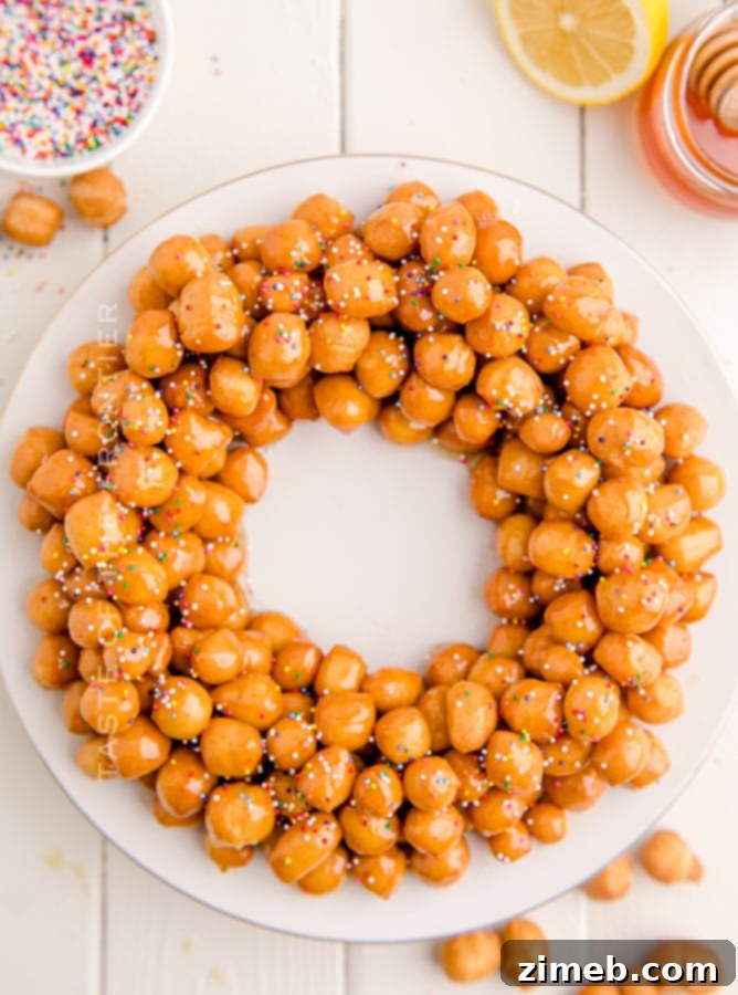A festive holiday dessert wreath made of Struffoli with colorful sprinkles