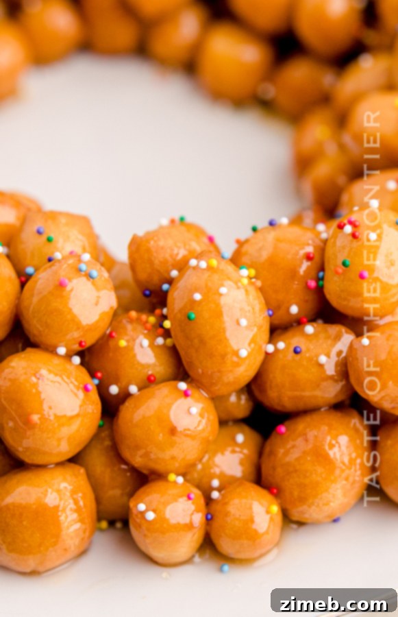 Close-up of glazed dough balls with festive sprinkles, showcasing the texture