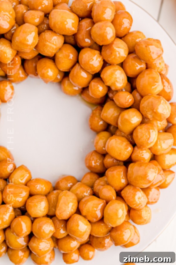 A festive Struffoli wreath, generously covered in sprinkles, ready for serving