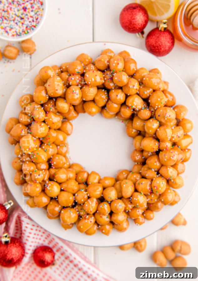 A final, appetizing shot of a Struffoli pyramid, glistening with honey and sprinkles