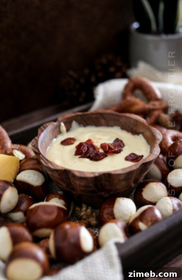 Bacon cheese dip with crunchy pretzels and fresh herbs