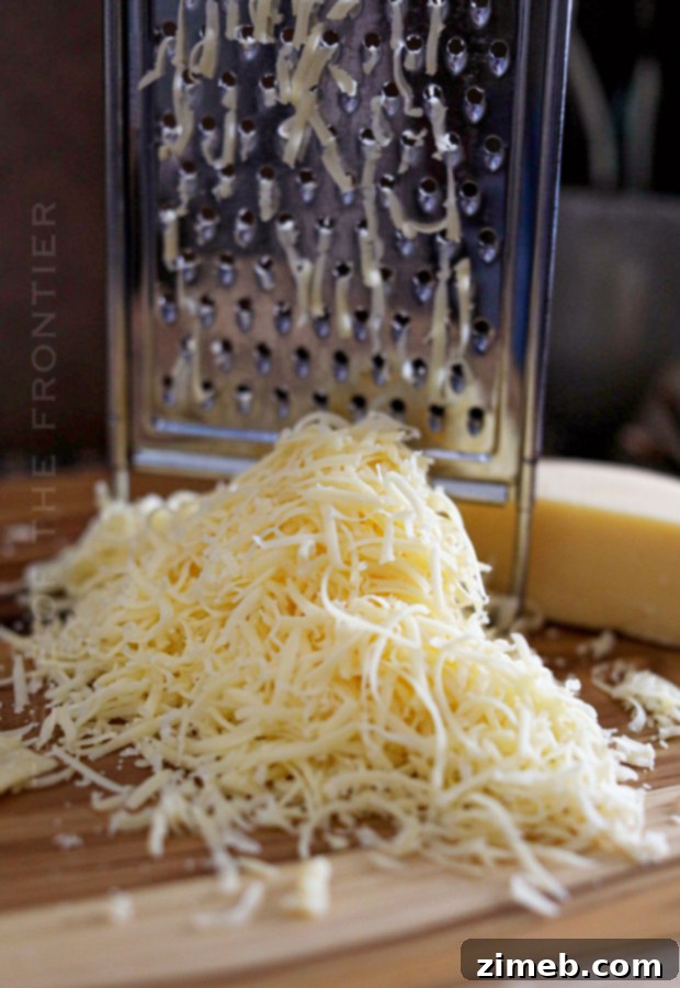 Shredded smoked gouda cheese, a key ingredient for a rich and creamy pretzel dip