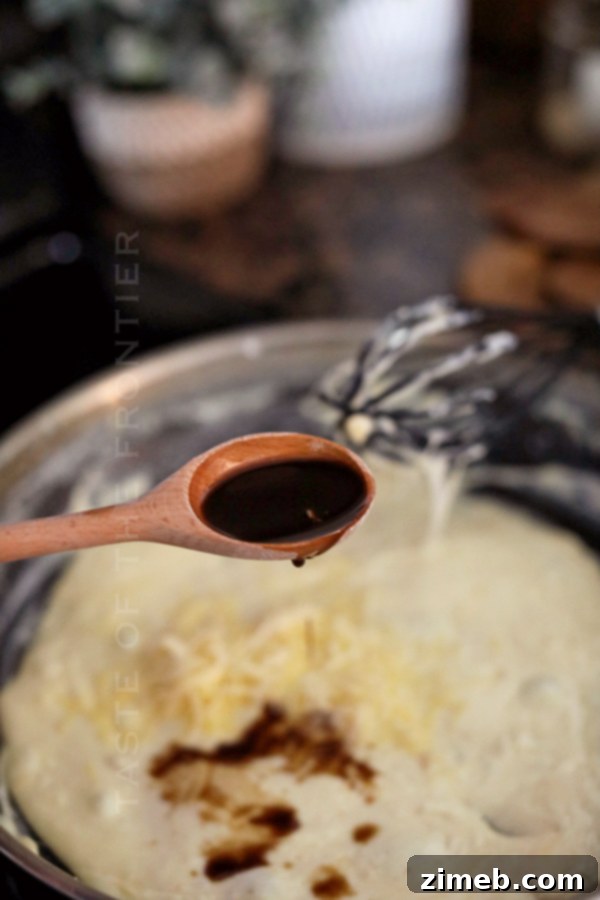 Bacon cheese dip served in a bowl with warm soft pretzels for dipping