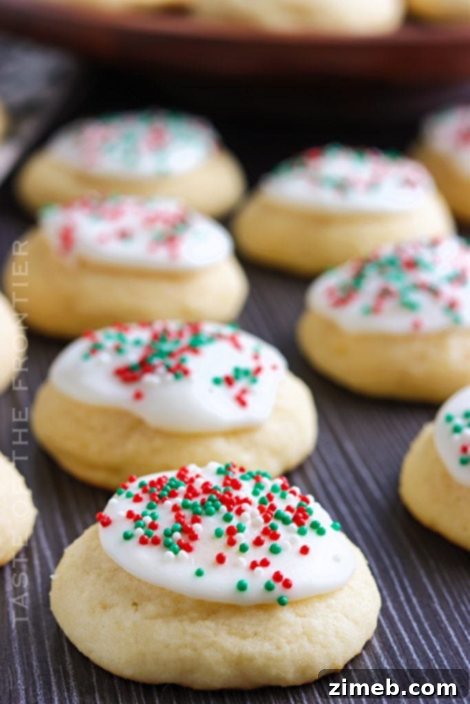 Melt-in-Your-Mouth Ricotta Delights 2 Holiday Ricotta Cookies, adorned with festive sprinkles, showcasing their soft, pillowy texture, perfect for Christmas or any celebration.