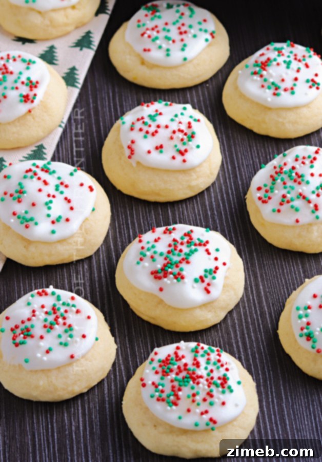 Melt-in-Your-Mouth Ricotta Delights 23 Festive holiday sprinkles adorn freshly glazed Italian Ricotta Cookies, ready to celebrate the season with a burst of color and flavor.