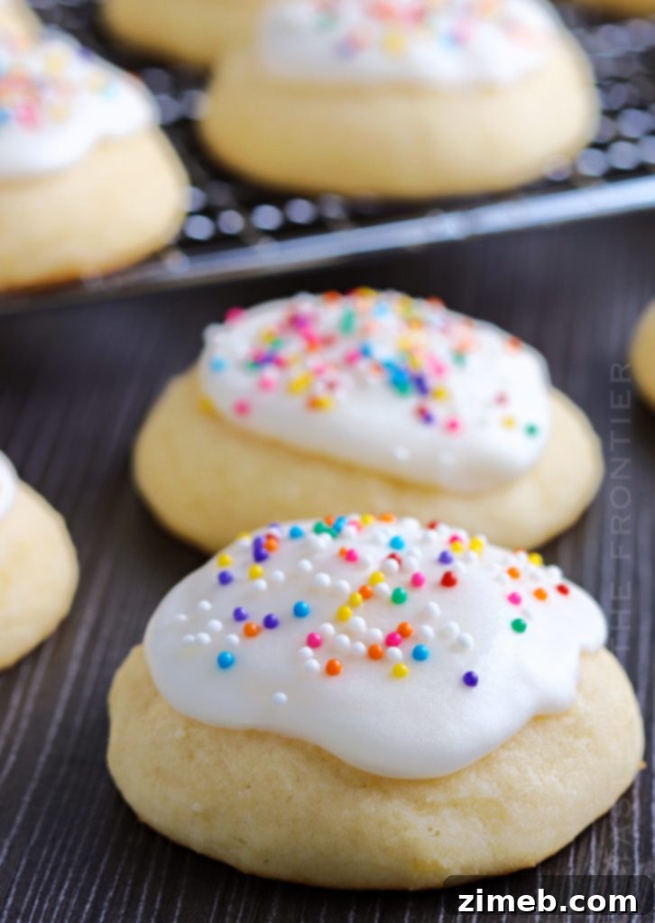 Melt-in-Your-Mouth Ricotta Delights 24 A close-up shot of a single Ricotta Cookie, perfectly glazed and topped with sprinkles, showcasing its inviting texture.
