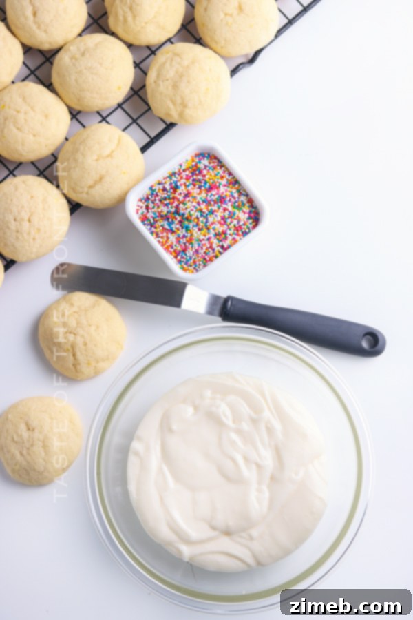 Melt-in-Your-Mouth Ricotta Delights 9 Adding a smooth, white frosting to freshly baked Ricotta Cookies, ready for sprinkles and final presentation.