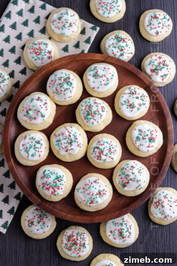 Melt-in-Your-Mouth Ricotta Delights 10 A festive platter of Christmas Ricotta Cookies, beautifully glazed and adorned with holiday sprinkles, embodying joyful celebrations.