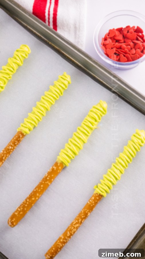 Grinch's Heart-Melting Pretzel Delights 9 Decorating Pretzel Rods with green chocolate and red hearts