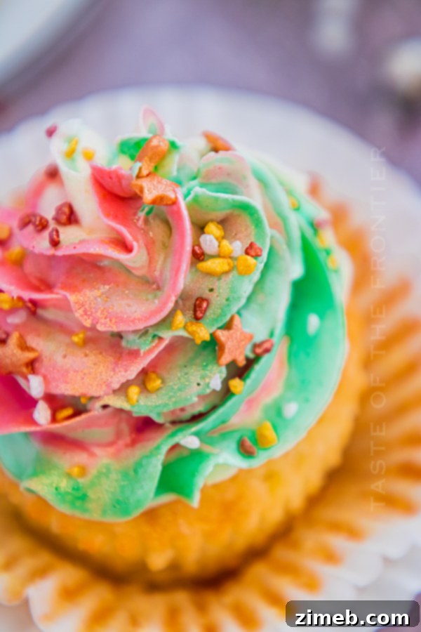 Holiday cupcake with shimmering red, green, and white swirled frosting