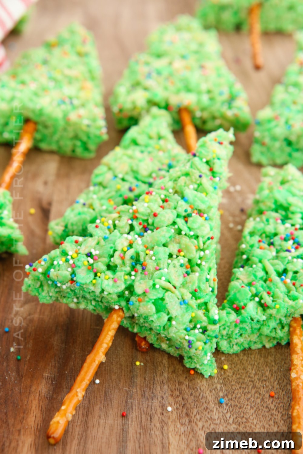 Yuletide Crispy Delights 2 Festive Christmas Rice Krispie Treats shaped like trees with sprinkles