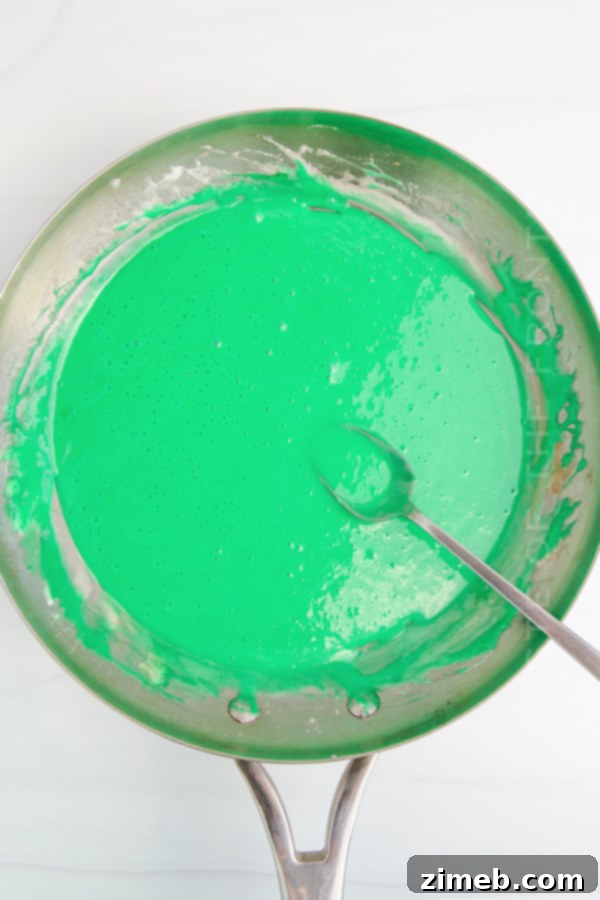 Yuletide Crispy Delights 7 Melted green marshmallow mixture in a saucepan