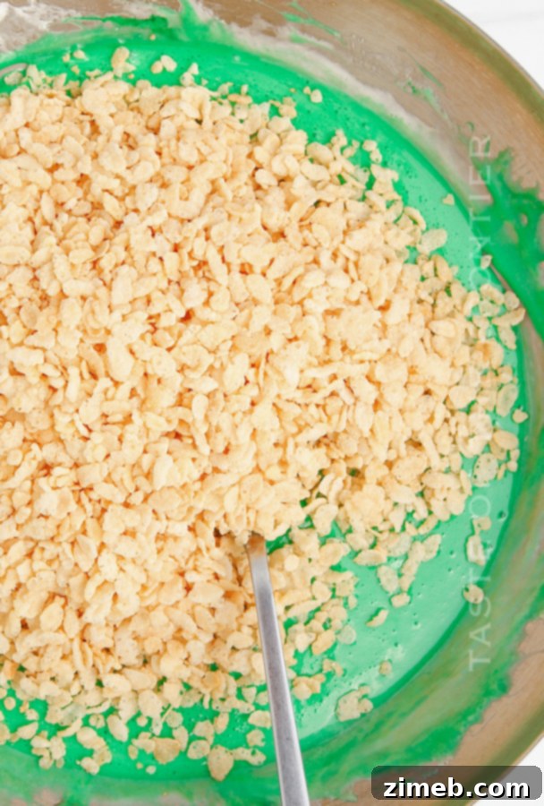 Yuletide Crispy Delights 8 Mixing Rice Krispie cereal into green marshmallow mixture