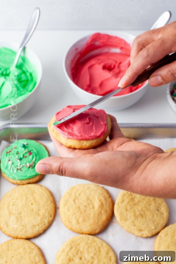 adding frosting to Christmas cookies