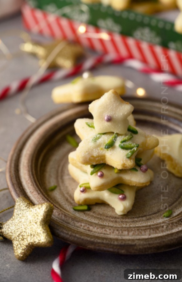 A stack of star-shaped white chocolate pistachio cookies
